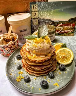 American pancakes topped with lemon gelato, blueberries, mint, and icing sugar, next to a pot of Spanish Spiced Fig gelato.