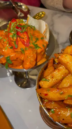 Colorful Indian street food spread with mocktails, butter chicken, and sharing platter at Saffron Street, Leicester.