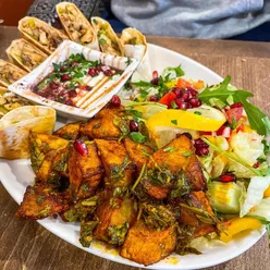 Damascena Harborne chicken shawarma arabiya with seasoned chicken, salad, garlic dressing, pickles in flatbread, batata hara side.