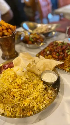 Delicious masala chips and chicken chow mein at Saffron Street, Leicester, with a strawberry mocktail drink.