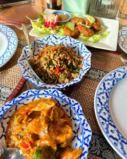 Delicious Thai dishes from Wolverhampton: Pad Ka Pao, Panang Curry, Thai Fish Cake, and crispy fried egg.