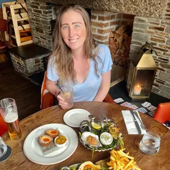 Enjoying seafood at Mariners in Rock, Cornwall: grilled Orkney scallop, oysters, scotch egg, skinny fries, with Blood Orange Gin.
