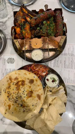 Nihari Biryani with tender lamb shank and mixed grill platter at Saffron Street, Leicester, showcasing Indian street food.