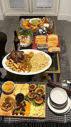 A variety of food boards featuring sushi, hotdogs, cheese, potatoes, nachos, and cakes, perfect for a fun night with friends.