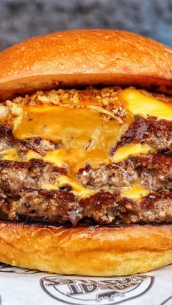 Delicious double cheeseburger with melted cheese and crispy fried chicken at Meatcastles, Yorkshire.