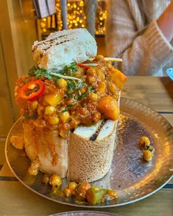 Mowgli Street Food Leeds: swing chairs, sparkly lights, green ginger rhubarb Dahl, Mowgli chip butty, shared dishes.