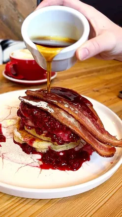 Delicious pancakes with bacon, berry compote, and maple syrup at House of Koko in Oakwood, Leeds.