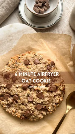 Single-serve airfryer chocolate oat cookie with banana, topped with chocolate chips, perfect for breakfast or dessert.