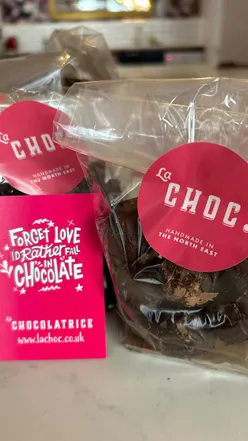 Group making chocolate truffles at La Chocolatrice, Newcastle. Learn chocolate crafting with expert Gill. Perfect for chocolate lovers.