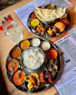 Fresh South Indian dishes at Dosa Kitchen Jesmond, featuring dosa, chutney, rice, rasam, and paapad in a welcoming atmosphere.