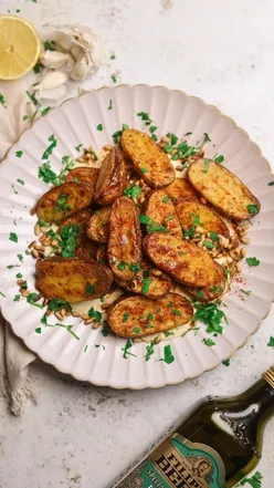 Roasted potatoes with homemade aioli, topped with crispy pine nuts, parsley, and paprika. Inspired by Nigella Lawson.