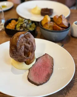 Welsh beef and Pembrokeshire lamb roasts at Thomas by Tom Simmons, with local ingredients, Malbec wine, and sticky toffee pudding.