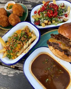 Delicious birria beef dip burger with rich dunking gravy, perfect for food lovers and burger enthusiasts.