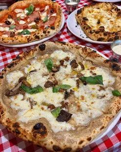 Truffle mushroom and prosciutto pizzas with garlic focaccia at Pizza Triangle, Nottingham; authentic Italian flavors, cozy vibe.