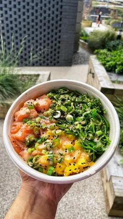 Colorful poki bowl with fresh fish, vegetables, and chopsticks from Honi Poke in Manchester
