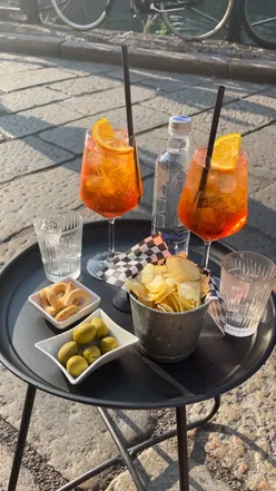 Enjoying Aperitivo in Milan with drinks and free snacks, perfect for summer gatherings and socializing.