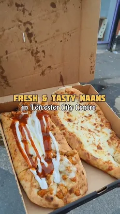 Freshly made naan with toppings in Leicester City Centre, showcasing delicious chicken fatayer and cheese pide.