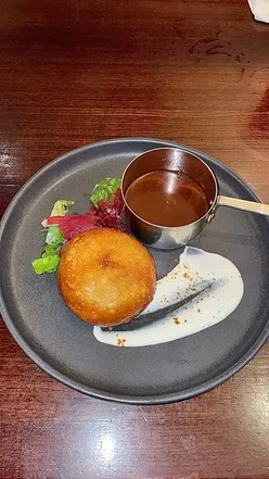 Slow Cooked Pulled Pork Donut with BBQ Beef sauce and Spiced Cauliflower Wings at Miller & Carter Enderby.