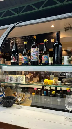 Small plates with sauces and wine at Les Enfants du Marché, perfect for a Parisian foodie adventure.
