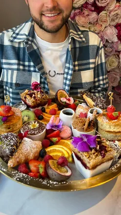 Colorful grazing board with fresh fruit, croissants, and drinks at SLT Bath, perfect for a bottomless brunch experience.