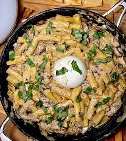 French onion, sausage, and burrata rigatoni with Gruyère, white wine, and thyme, perfect for cozy home-cooked meals.
