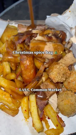 Christmas spice bag with glazed turkey, ham, stuffing balls, skin-on fries, honey carrots, parsnips, roasties, and embotido gravy at Lasa Belfast.