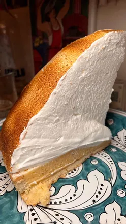 A towering nine-inch lemon meringue pie with a crumbly crust and fluffy meringue, perfect for dessert lovers.