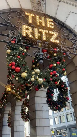 Afternoon tea at The Ritz London with rose champagne, sandwiches, cakes, scones, and Christmas carols.