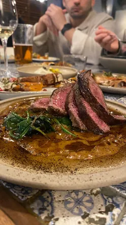 Family dining at Maray, Albert Dock, Liverpool; vibrant dishes and drinks on table, enhancing culinary experience.
