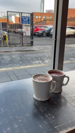 Apple butter latte and winter berry warmer drinks from Established Coffee, enjoyed on a cozy morning as 2023 ends.