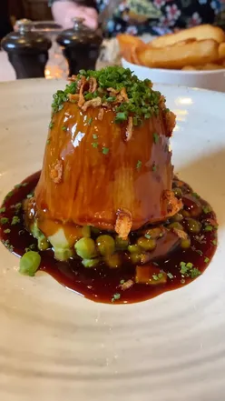 Hearty suet pudding at Freemasons at Wiswell, a cozy Lancashire gastropub with countryside views and Michelin Guide acclaim.