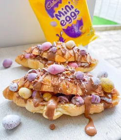 Mini egg croissant with melted chocolate drizzle, perfect Saturday breakfast treat for chocolate lovers.