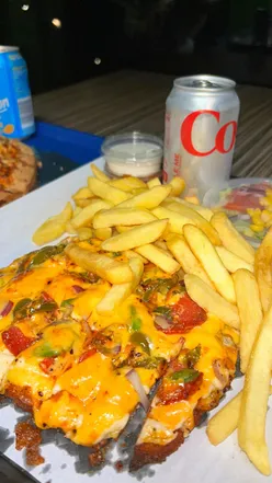 Delicious half piri piri, half chicken tikka pizza with deep pan crust and garlic sauce at Pizza and Co. West Road.