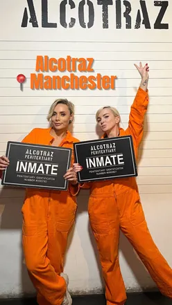 Group enjoying cocktails at ALCOTRAZ Manchester, immersed in a fun, interactive escape experience.