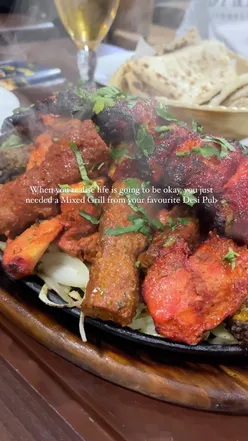 Delicious mixed grill platter at The Grove Bar and Grill in Birmingham, showcasing vibrant food and flavors.