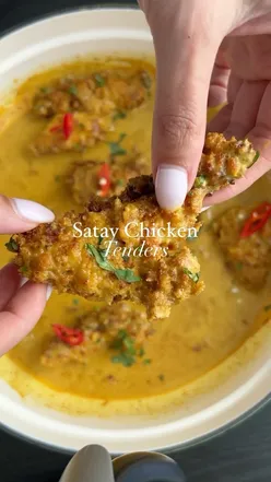 Air-fried satay chicken tenders with peanut sauce, served with egg fried rice; a healthy, protein-rich fakeaway meal.