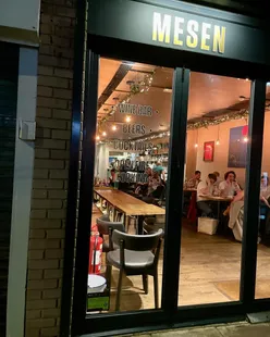 Charcoal-cooked dishes at Mesen Cardiff: Riverside sourdough with herb butter, white asparagus with Parmesan walnuts, chicken livers with bacon on sourdough, black seabass with jerk spice, and ox cheek tacos with pico de gallo.