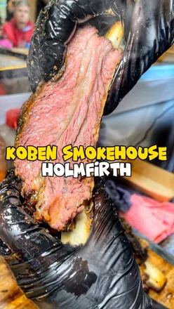 Succulent smoked BBQ meats at Koben Smokehouse, the UK's smallest BBQ spot, featuring Dino bones and crispy wings.