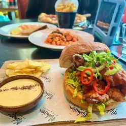 Spicy buffalo chicken burger with blue cheese sauce and crispy chips at Malmaison Hotel, Liverpool.