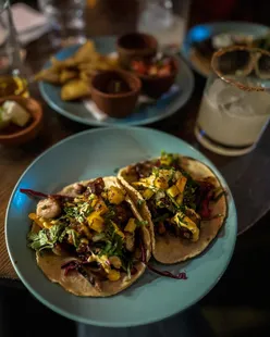 Pulpo tacos with crispy octopus, allioli, pineapple, salsa verde; corn patties with chorizo, crema, sheep's cheese at Paz Tacos, Edinburgh.