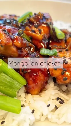 Delicious Mongolian chicken stir-fry with spring onions and sesame seeds served over jasmine rice.