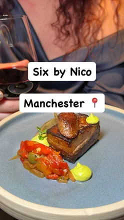 Enjoying a Greek-Mediterranean tasting menu with wine at Six by Nico in Manchester, featuring vibrant dishes and flavors.