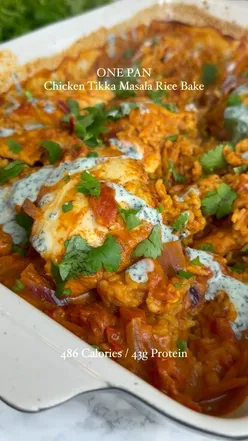 Chicken Tikka Masala Rice Bake with boneless chicken thighs, tikka curry, red onion, tomatoes, and rice, garnished with mint yogurt and coriander.