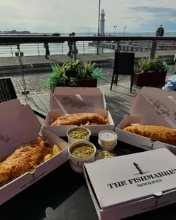 Fresh fish and chips at The Fish Market Newhaven, Edinburgh, enjoyed outdoors with a view and lovely weather.