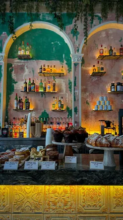 Moody Glasgow café interior with dim lighting, serving specialty coffee from local roasters and pastries from local bakeries.