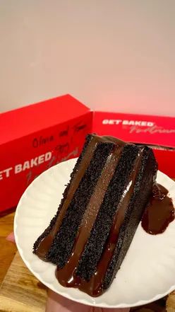 A stunning 24-layer chocolate Bertha cake from Fortnum's, showcasing rich ganache and vibrant colors.