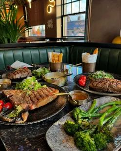 Celebrating at Parrilla Loanhead with medium-rare rump and T-bone steaks, steak chips, Parmesan mash, and grilled chilli broccoli.