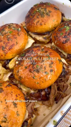 Delicious garlic pulled beef sliders on brioche buns with cheese and caramelized onions, perfect for summer gatherings.