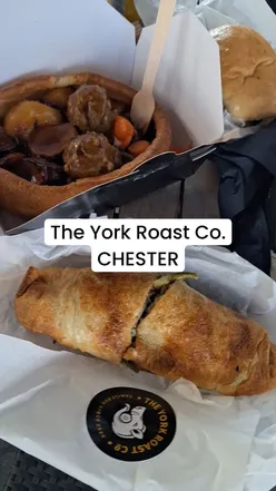 Yorkshire puddings with veggie roast, pork wrap, beef sandwich, roasties, and crackling at The York Roast Co, Chester.