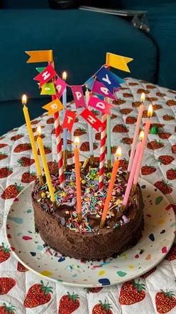 Remy celebrates a tooth party with a cake from Lazy Day Foods, joyfully blowing out candles after losing a tooth.